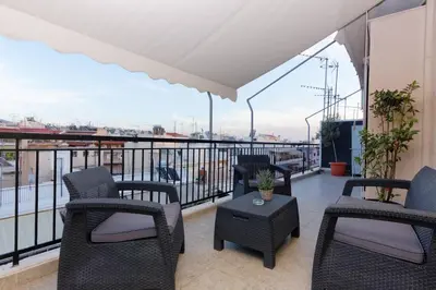 a balcony with chairs and a table with a view at Big terrace near metro and Athens center in Athens