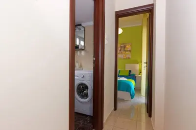 a room with a washing machine and a bedroom at Big terrace near metro and Athens center in Athens