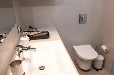 a bathroom with a white sink and a toilet at Luxury studio in Greek island style in Athens