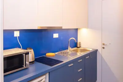 a small kitchen with a sink and a microwave at Luxury studio in Greek island style in Athens