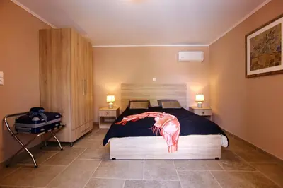 a bedroom with a bed with a plastic animal on it at GK Mediterranean Village - Airport Free Shuttle by GK Properties in Markopoulo