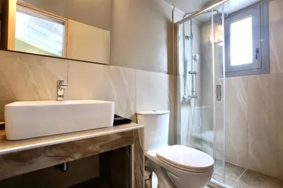 a bathroom with a toilet and a sink and a shower at GK Mediterranean Village - Airport Free Shuttle by GK Properties in Markopoulo