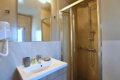 a bathroom with a sink and a shower at GK Mediterranean Village - Airport Free Shuttle by GK Properties in Markopoulo