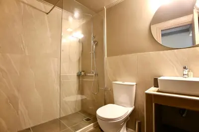 a bathroom with a shower and a toilet and a sink at GK Mediterranean Village - Airport Free Shuttle by GK Properties in Markopoulo