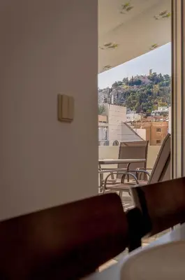 a balcony with chairs and a view of a city at Penthouse 2Bd apartment in the heart of Koukaki in Athens