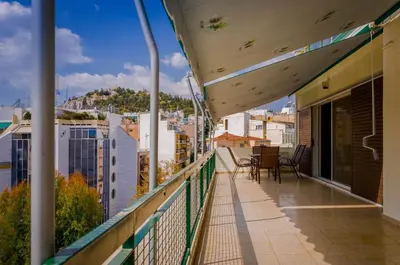 a balcony with chairs and a view of a city at Penthouse 2Bd apartment in the heart of Koukaki in Athens