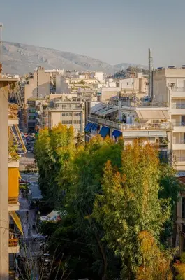 a view of a city with buildings and trees at Penthouse 2Bd apartment in the heart of Koukaki in Athens