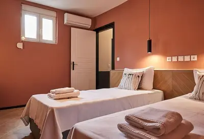 a room with two beds with towels on them at Flyin' High Luxury Suite in Metókhi