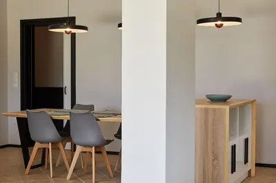a dining room with a table and chairs at Flyin' High Luxury Suite in Metókhi