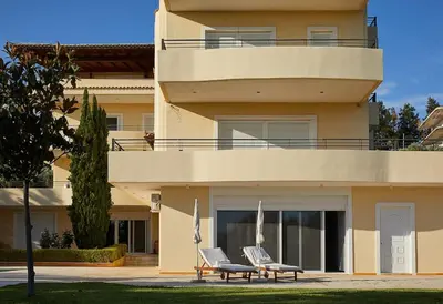 a building with two chairs in front of it at Flyin' High Luxury Suite in Metókhi