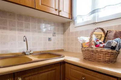 a kitchen with a sink and a basket on the counter at Beautiful house in Chalandri in Athens