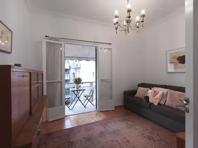 a living room with a couch and a glass door at Fyllis17 - Cozy apartment in the heart of Athens in Athens