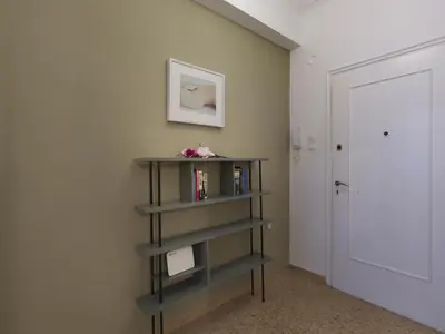 a book shelf in a room with a door at Fyllis17 - Cozy apartment in the heart of Athens in Athens