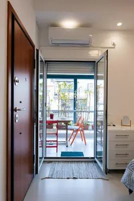 a room with a door leading to a patio with a table at Modern studio apartment B in Athens