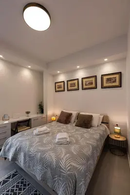 a bedroom with a large bed with two pillows at Modern studio apartment B in Athens