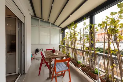 a balcony with a table and chairs and plants at Modern studio apartment B in Athens