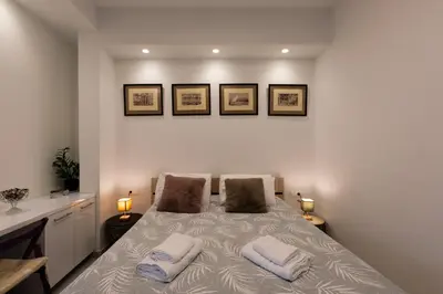 a bedroom with a bed with two pillows on it at Modern studio apartment B in Athens