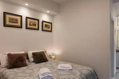 a bedroom with a bed with two towels on it at Modern studio apartment B in Athens