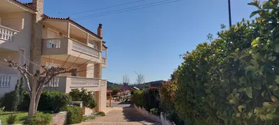 a street in a town with a building at Evelina's studio in Artemida