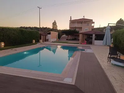 a swimming pool in the backyard of a house at Evelina's studio in Artemida