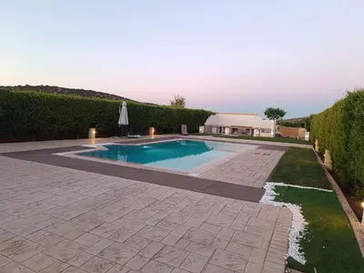 a swimming pool in a yard with a patio at Evelina's studio in Artemida