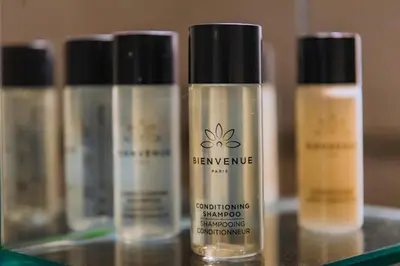 three bottles of beauty products sitting on a shelf at Acropolis Studio Apartment in Athens