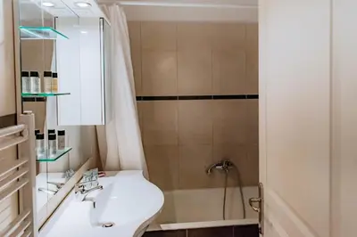 a bathroom with a sink and a shower at Acropolis Studio Apartment in Athens