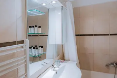 a bathroom with a sink and a shower at Acropolis Studio Apartment in Athens