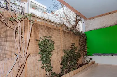 a brick wall with a green screen in a building at Acropolis Studio Apartment in Athens