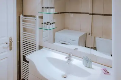 a bathroom with a sink and a toilet and a mirror at Acropolis Studio Apartment in Athens