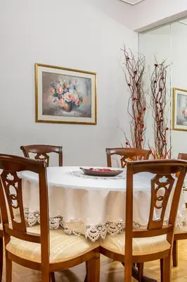 a dining room table with a white table cloth on it at Athens Walk in Athens