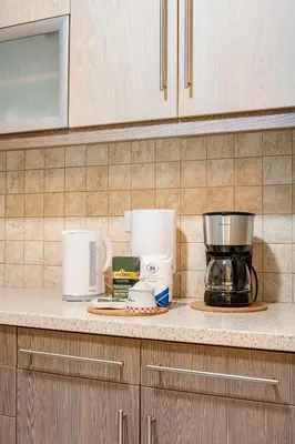 a kitchen counter with a coffee maker and other items at Athens Walk in Athens