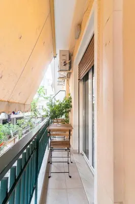 a balcony with a table and chairs on it at Athens Walk in Athens