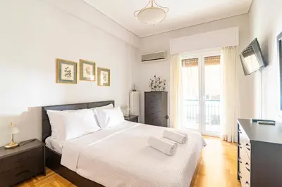 a bedroom with a bed with two towels on it at Athens Walk in Athens