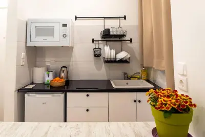 a small kitchen with a sink and a microwave at Acropolis Explorer Studio by WeHost Athens in Athens