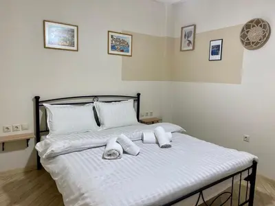 a bedroom with a bed with white towels on it at A modern flat in the centre in Athens