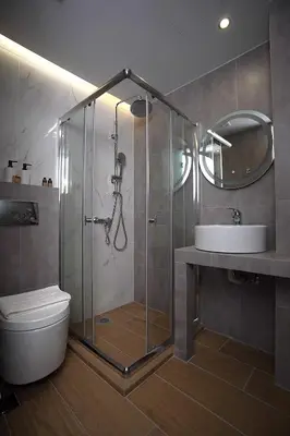a bathroom with a shower and a toilet and a sink at TiP - ToP Suites in Athens