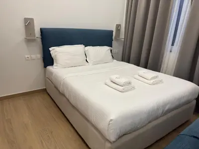 a bedroom with a bed with two towels on it at TiP - ToP Suites in Athens