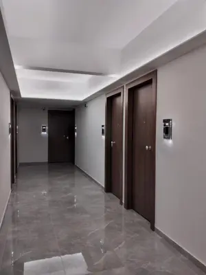 an empty hallway with wooden doors and a tile floor at TiP - ToP Suites in Athens