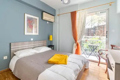 a bedroom with a bed with a yellow towel on it at Sunny apartment right under Parthenon in Athens