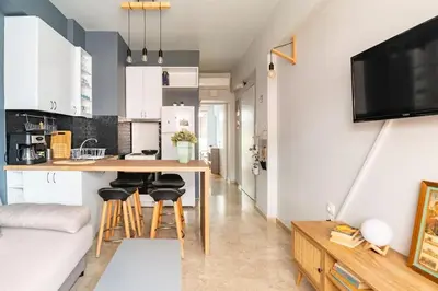 a kitchen with a table and chairs in a room at Sunny apartment right under Parthenon in Athens