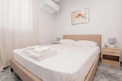 a bedroom with a white bed with towels on it at COMFY Flat, Athens city center in Athens