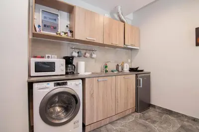 a kitchen with a washing machine and a microwave at COMFY Flat, Athens city center in Athens