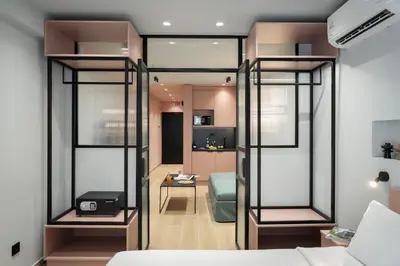 a room with glass dividers in a bedroom at Dion Luxury Suites in Athens