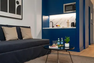 a living room with a couch and a table at Dion Luxury Suites in Athens