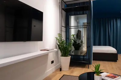 a living room with a mirror and a bed at Dion Luxury Suites in Athens