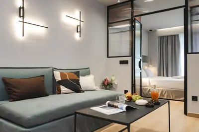 a living room with a couch and a table at Dion Luxury Suites in Athens