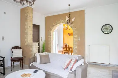 a living room with a couch and a table at Spacious 2 bedroom apartment at Glifada in Athens