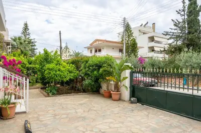 a garden with potted plants and a fence at Spacious 2 bedroom apartment at Glifada in Athens