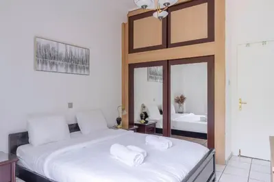 a bedroom with two beds with white towels on them at Spacious 2 bedroom apartment at Glifada in Athens